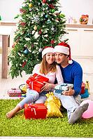 Young couple celebrating christmas at home [IBR125053262]