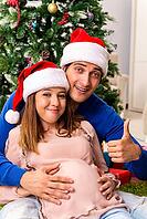 Pregnant wife celevrating christmas with husband [IBR125053266]