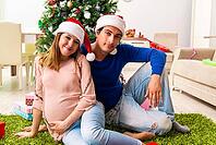 Pregnant wife celevrating christmas with husband [IBR125053267]
