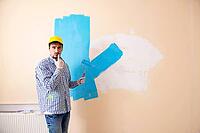 Painter man painting the wall at home [IBR125062162]