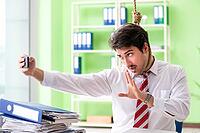 Despaired businessman thinking of suicide in the office [IBR125062166]