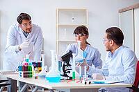 Team of chemists working in the lab [IBR125062169]