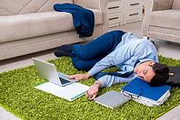 Tired and exhausted businessman relaxing after hard day [IBR125062175]