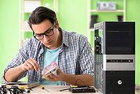 Computer engineer repairing broken desktop [IBR125062177]
