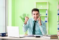 Male financial manager working in the office [IBR125062183]