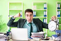 Businessman angry with excessive work sitting in the office in time management concept [IBR125062193]