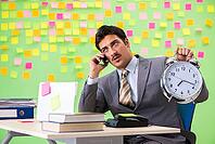 Businessman with many conflicting priorities in time management concept [IBR125062194]