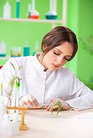 Beautiful female biotechnology scientist chemist working in lab [IBR125062211]