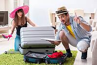 Young family packing for vacation travel [IBR125062213]