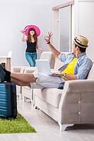 Young pair packing for summer vacation travel [IBR125062217]