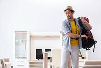 Backpacker packing for his trip [IBR125062219]