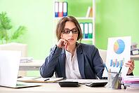 Female financial manager presenting graph chart sitting in the office [IBR125062221]