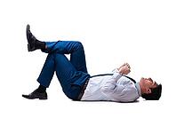 Businessman lying on the floor isolated on white [IBR125062223]