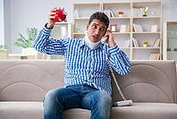 Young man suffering from neck injury at home [IBR125062229]