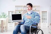 Young man suffering from injury on wheelchair at home [IBR125062230]