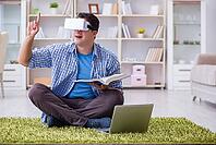Freelance student with virtual reality glasses at home [IBR125062235]