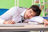 Sick and unhappy businessman sitting in the office [IBR125062253]