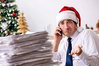 Young worker working in office on christmas shift [IBR125075735]