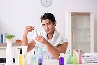 Young handsome man in the bathroom in hygiene concept [IBR125075736]