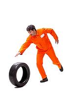 Young garage worker with tyre isolated on white [IBR125075738]