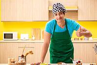 Young professional cook preparing in kitchen [IBR125075748]