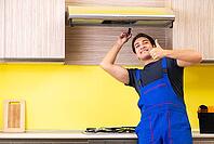 Young service contractor assembling kitchen furniture [IBR125075751]