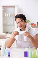 Young handsome man in the bathroom in hygiene concept [IBR125075753]