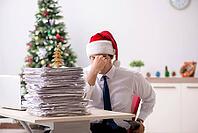 Young worker working in office on christmas shift [IBR125075759]