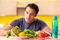 Young man in dieting and healthy eating concept [IBR125075764]
