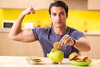 Young man in unhealthy food concept [IBR125075768]