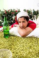 Young man drunk at home after christmas party [IBR125075775]