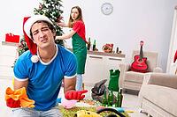 Young family cleaning apartment after christmas party [IBR125075776]