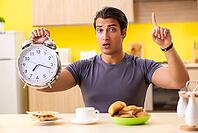 Young man in unhealthy food concept [IBR125075779]