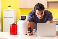 Young man blogging about food additives [IBR125075807]