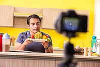 Young man blogging about food supplements [IBR125075810]