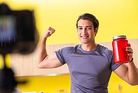 Young man blogging about food supplements [IBR125075811]