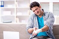 Young student man with injury at home [IBR125094345]