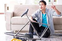 Young man repairing bicycle at home [IBR125094346]
