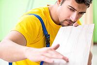 Professional contractor laying flooring at home [IBR125094347]