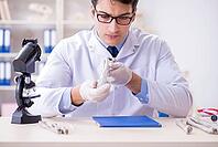 Professor studying human skeleton in lab [IBR125094352]