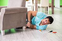 Man repairing furniture at home [IBR125094357]