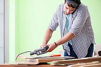 Woodworker working in his workshop [IBR125094358]