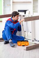Repair contractor repairing broken furniture at home [IBR125094360]