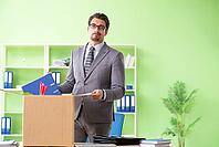 Male employee collecting his stuff after redundancy [IBR125094363]