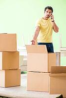 Young handsome man moving in to new house with boxes [IBR125094368]