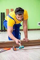 Professional contractor laying flooring at home [IBR125094376]