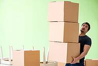 Man moving house with boxes [IBR125094383]