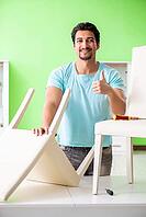 Man repairing furniture at home [IBR125094384]