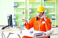 Construction supervisor planning new project in office [IBR125094389]