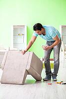 Man repairing furniture at home [IBR125094392]
